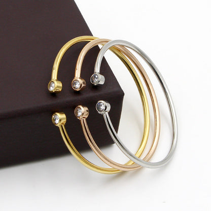 Złota otwarta bransoletka z bliźniaczymi kryształami